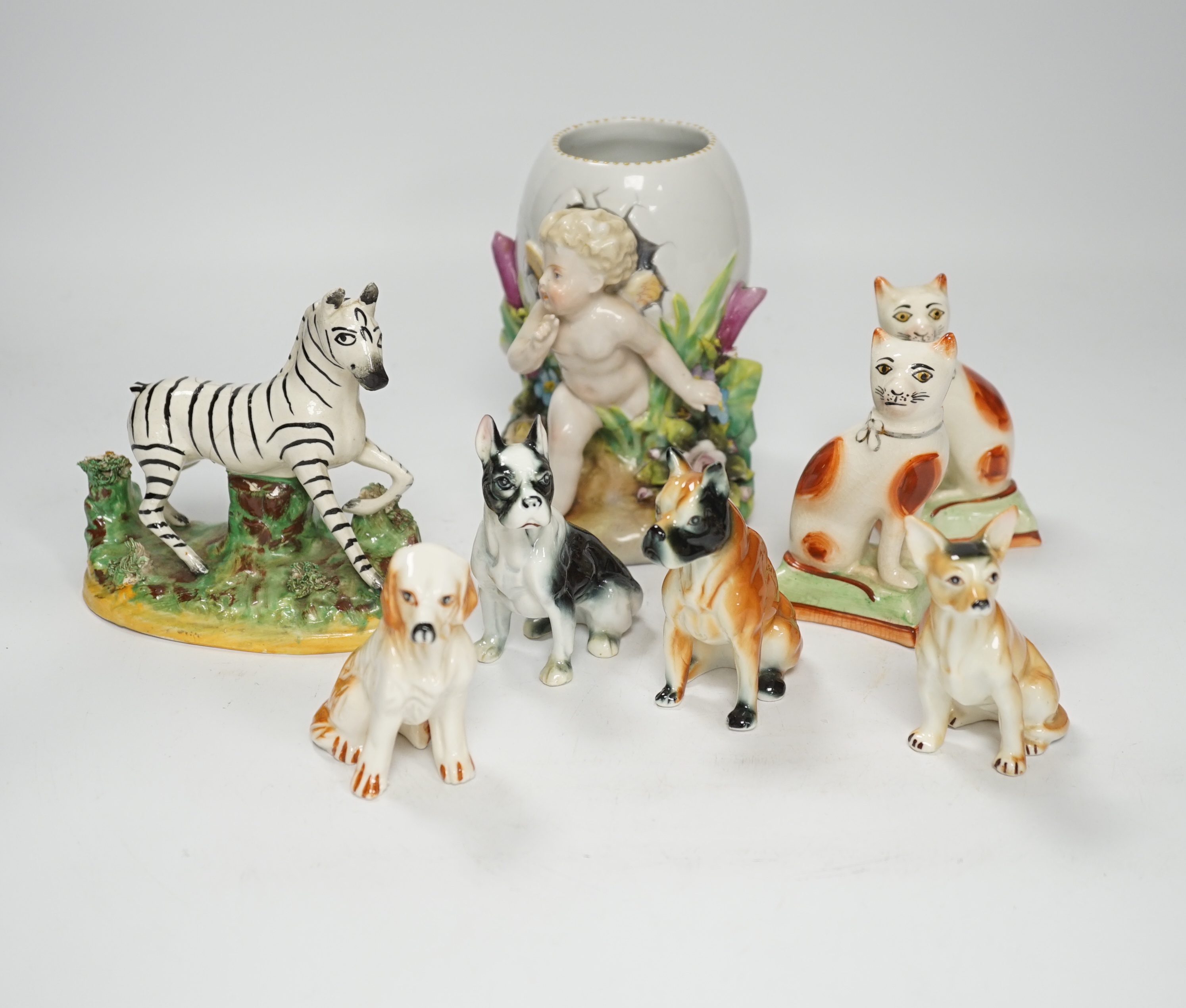 A 19th century Staffordshire zebra and mixed animals and putti ceramics, tallest putti vase 13.5cm high (14)